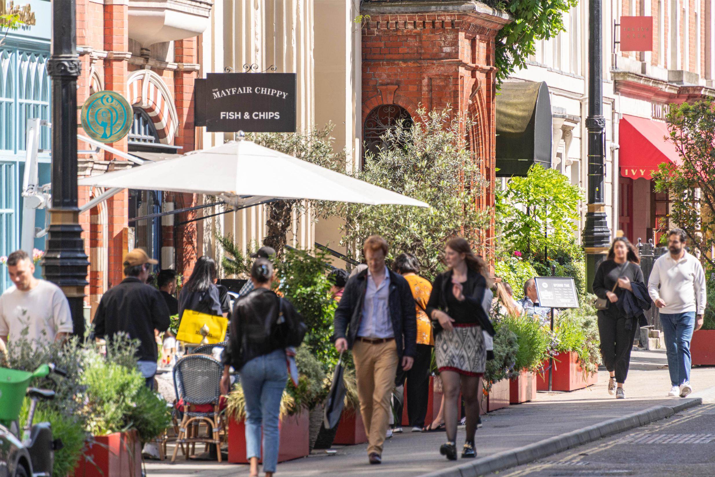 People walking past cafe on high street