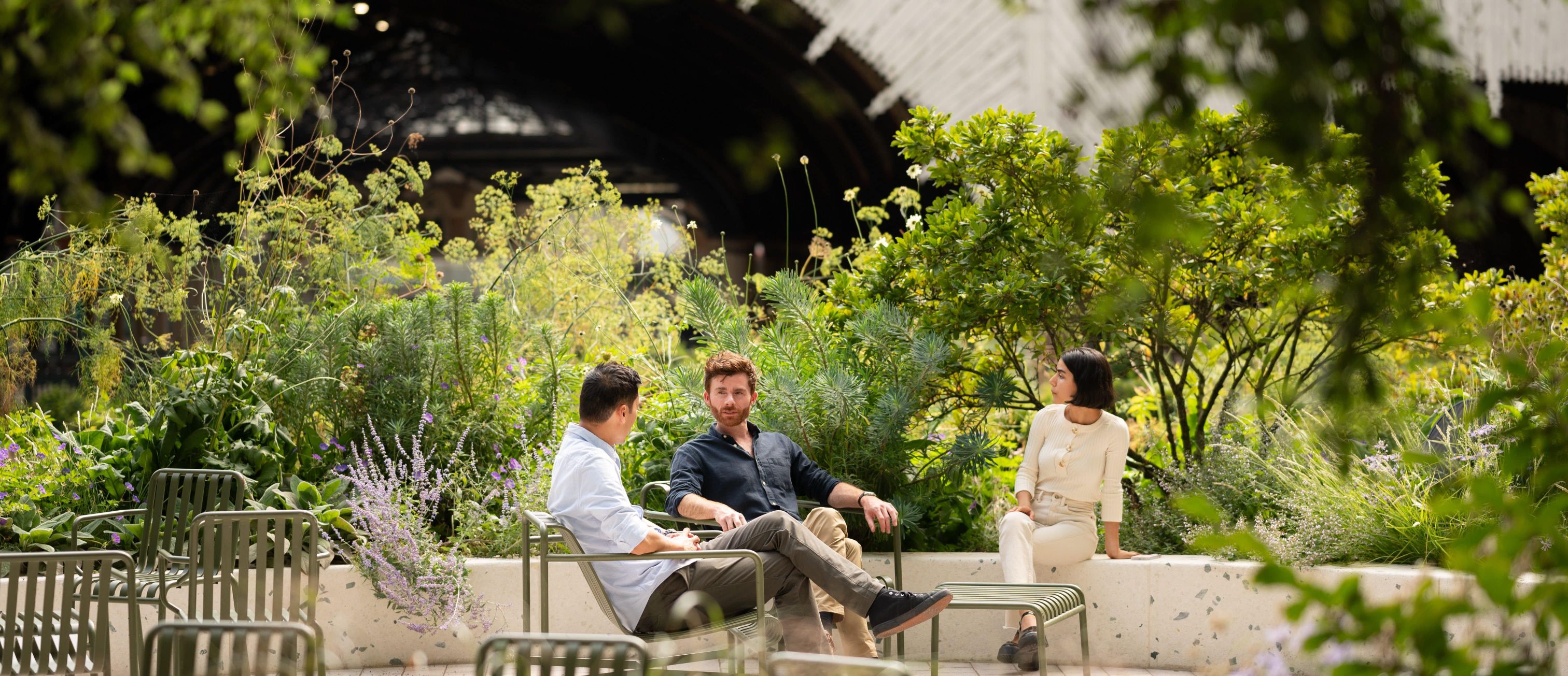 A group of people having a chat in a park in Broadgate